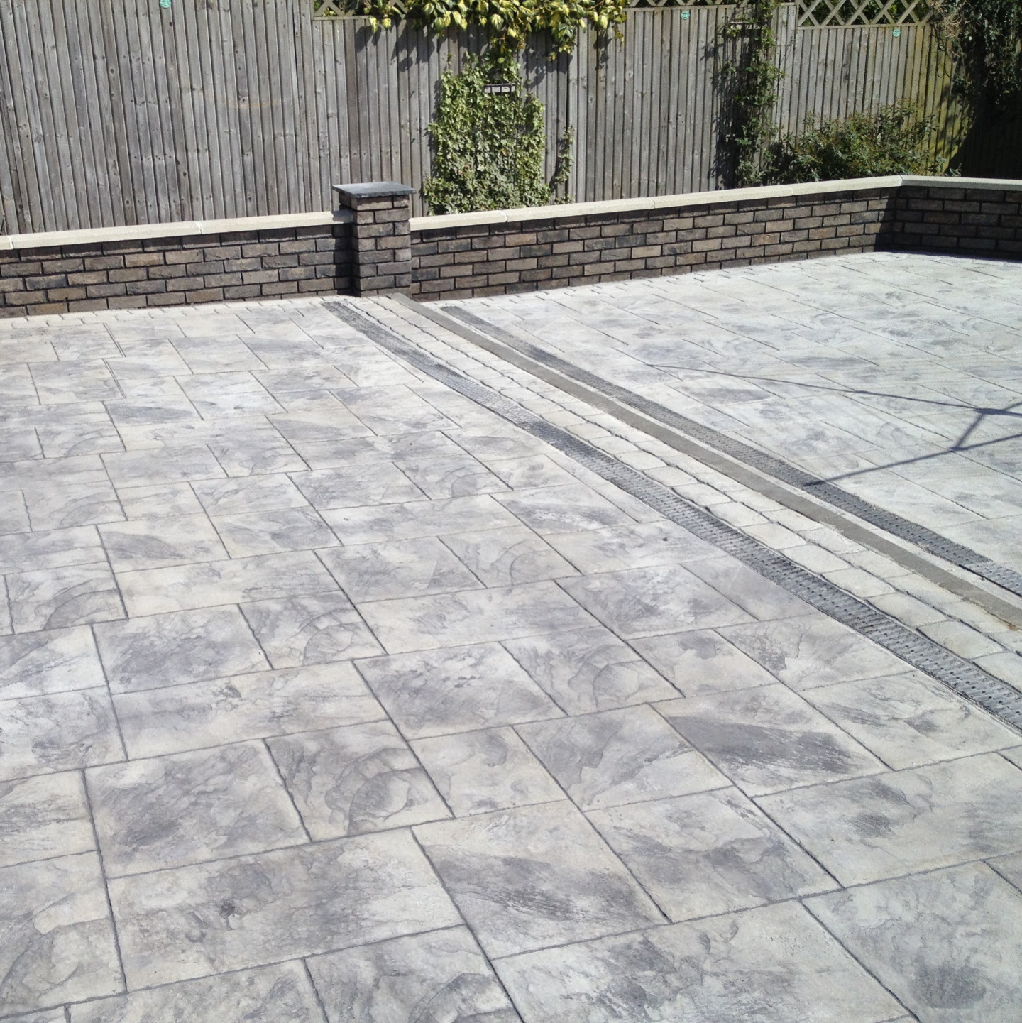 Imprinted slate grey concrete patio with built in Aco drianage channels